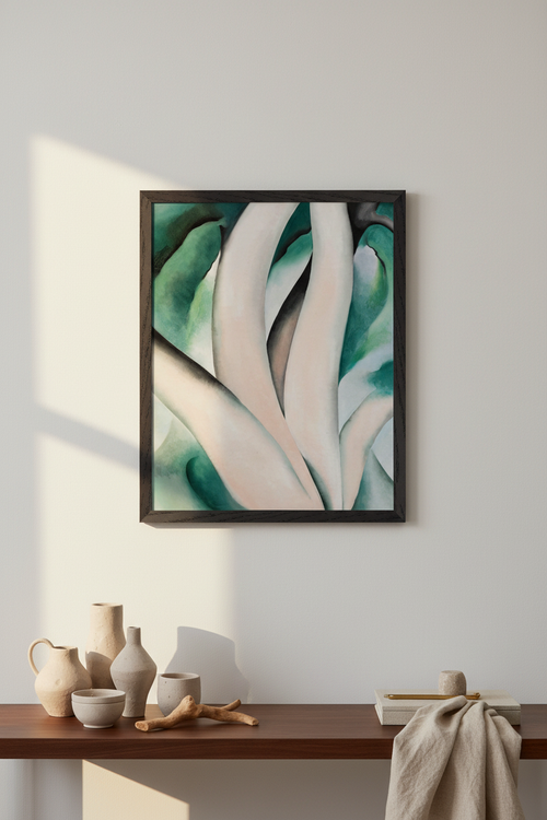 Framed abstract artwork on a wall above a wooden shelf with decorative items. Birch Trees at Dawn on Lake George by Georgia O’Keeffe displayed in refined American interior, Collector’s Edition museum-quality art print